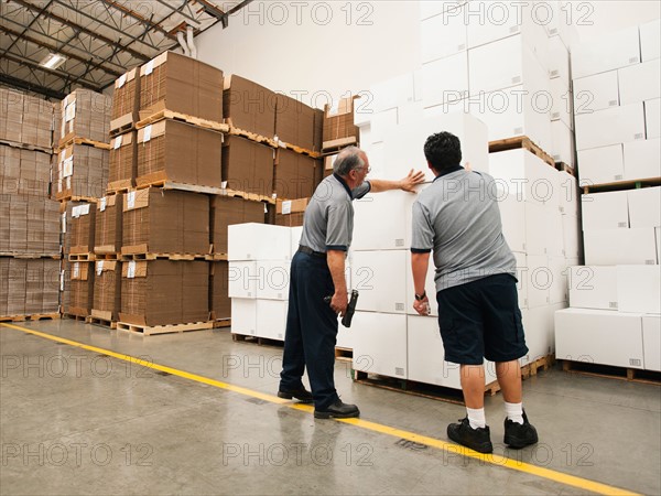 Warehouse workers inspecting delivery.