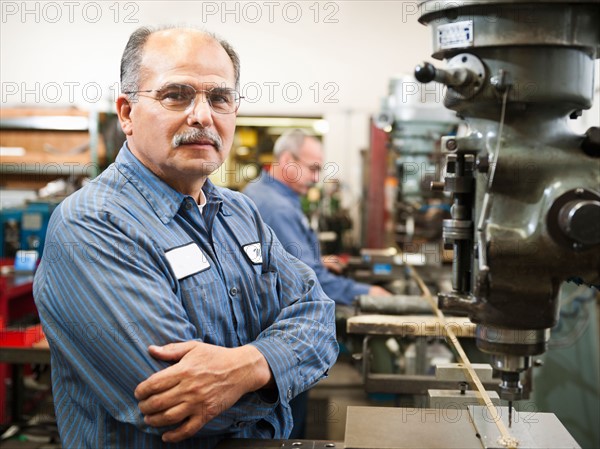 Portrait of skilled worker in factory.