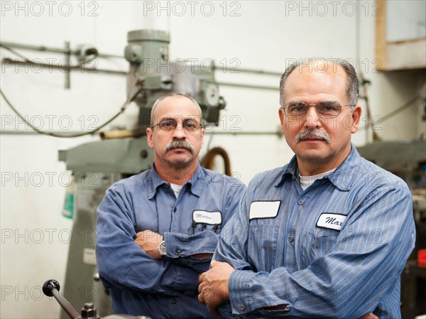 Portrait of skilled workers in factory.