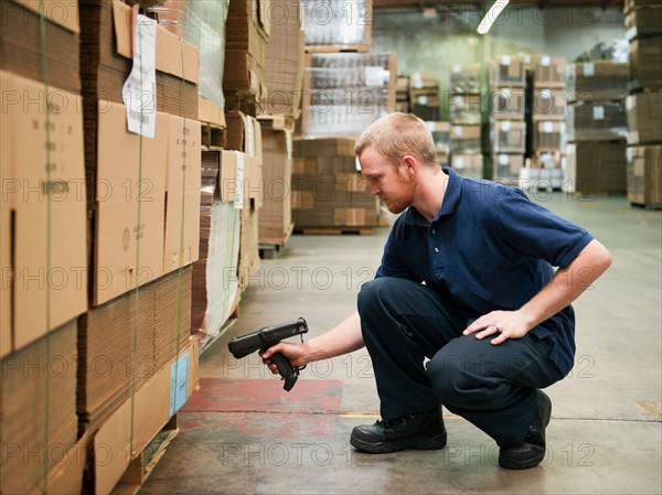 Warehouse worker scanning delivery.
