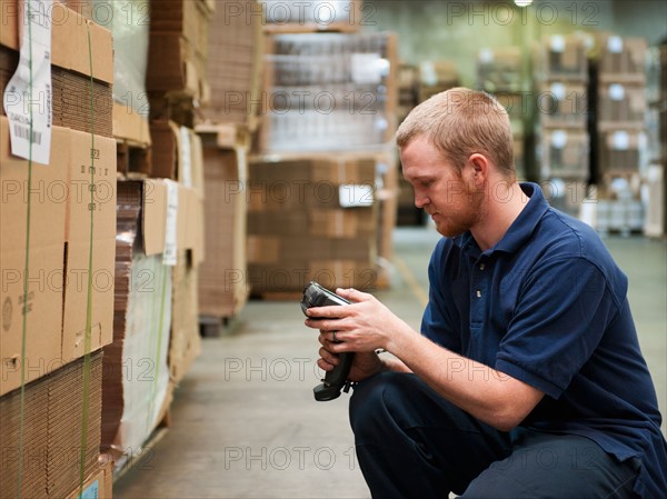 Warehouse worker scanning delivery.