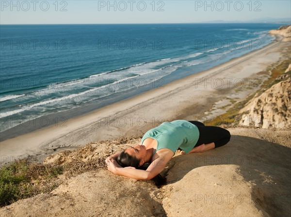 USA, California, San Diego, Woman practicing yoga on beach.