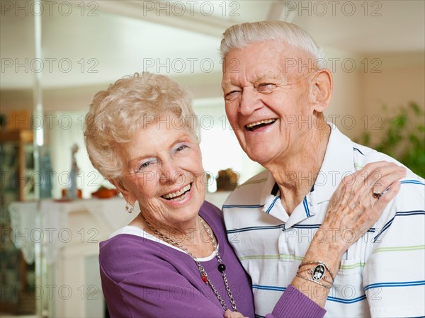 Portrait of senior couple laughing.