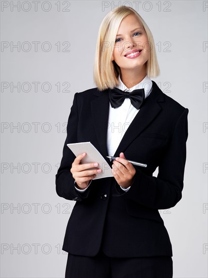 Studio portrait of young waitress. Photo : Yuri Arcurs