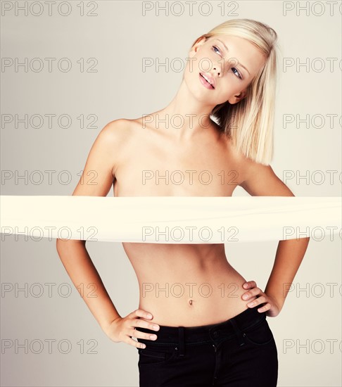 Studio portrait of young shirtless woman. Photo : Yuri Arcurs