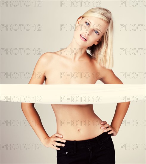 Studio portrait of young shirtless woman. Photo : Yuri Arcurs