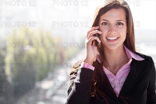 Young businesswoman talking via mobile. Photo : Take A Pix Media