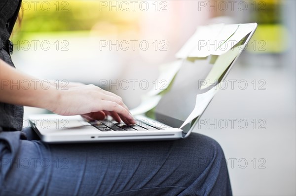 Close-up of hands of businesswoman using laptop. Photo : Take A Pix Media