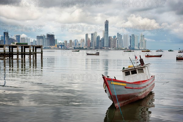 Panama, Panama City, Fishing boat with skyline in background. Photo : DreamPictures