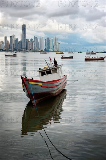 Panama, Panama City, Fishing boat with skyline in background. Photo : DreamPictures