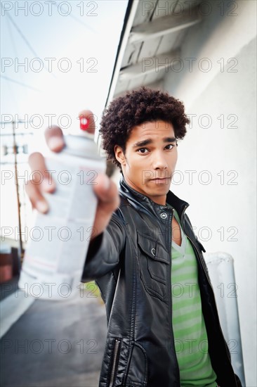 Portrait of man holding spray paint. Photo : Sarah M. Golonka