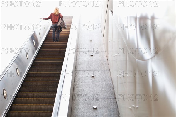 USA, California, Los Angeles, Woman on escalator in subway station. Photo : Sarah M. Golonka