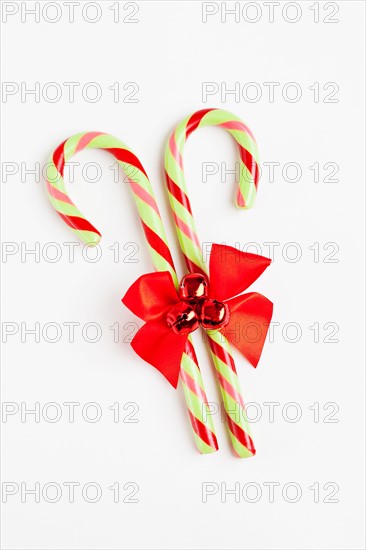 Striped candy canes with red ribbon, studio shot. Photo : Sarah M. Golonka