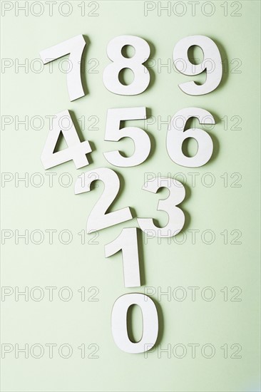 Numbers on white background, studio shot. Photo : Kristin Lee