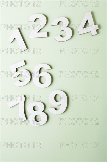 Numbers on white background, studio shot. Photo : Kristin Lee