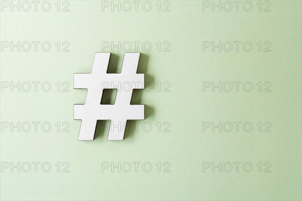 Hashtag on white background, studio shot. Photo : Kristin Lee