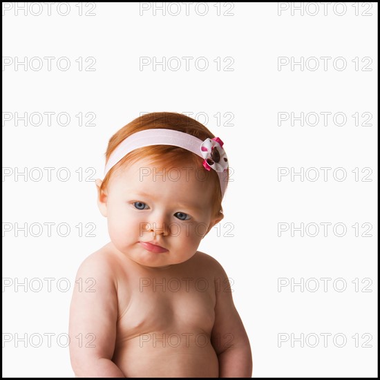 Portrait of baby girl (6-11 months), studio shot. Photo : Mike Kemp