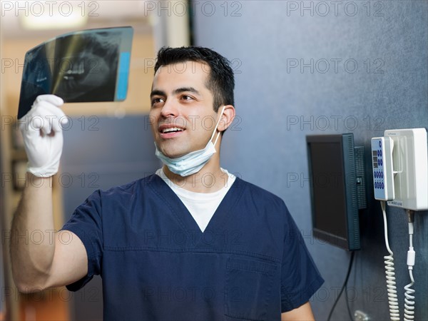 Portrait of dentist holding x-ray . Photo : Dan Bannister