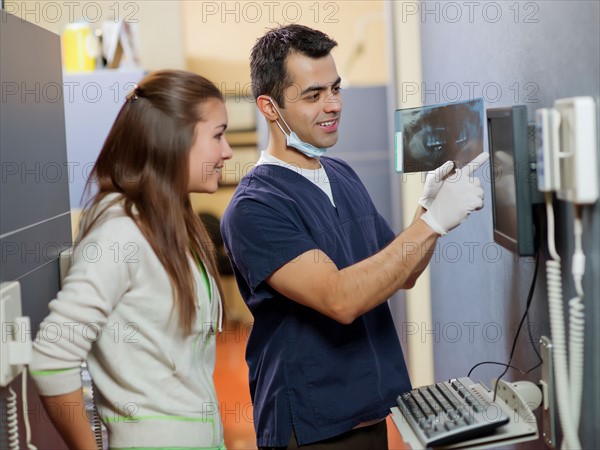 Dentist and patient looking at x-ray . Photo : Dan Bannister