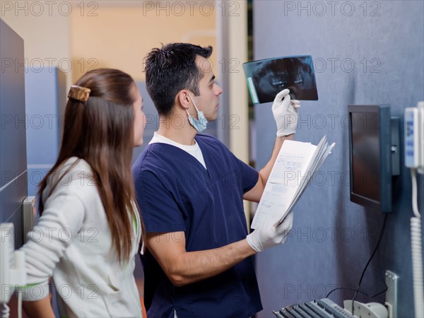 Dentist and patient looking at x-ray . Photo : Dan Bannister