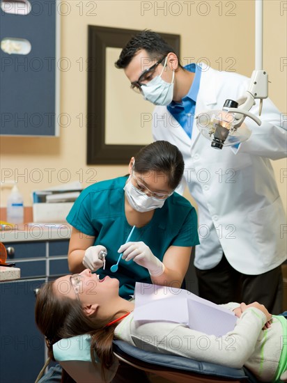 Dentists and patient in dental surgery. Photo : Dan Bannister