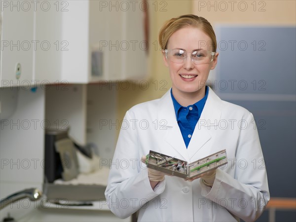 Portrait of dentist holding dental tools. Photo : Dan Bannister