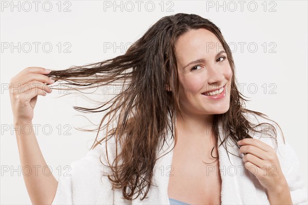 Portrait of woman with long wet hair, studio shot. Photo : Jan Scherders