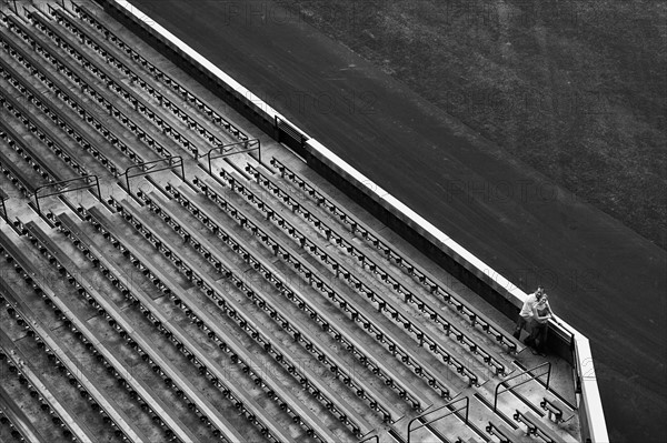 Distant view of couple and stadium bleachers. Photo : King Lawrence