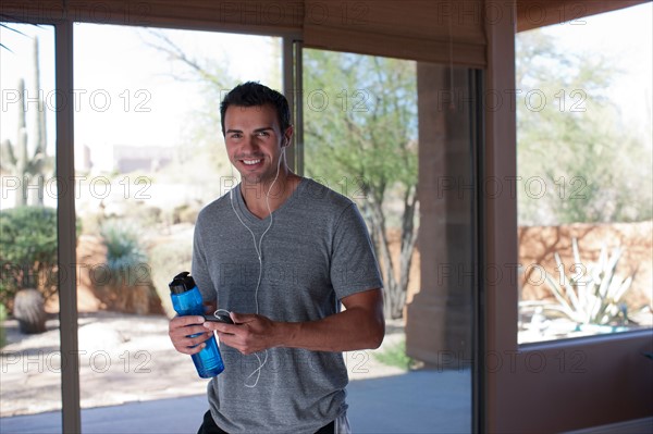 Portrait of man holding water bottle. Photo : db2stock