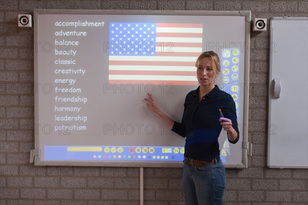 Teacher giving instructions at digital board. Photo : Mark de Leeuw