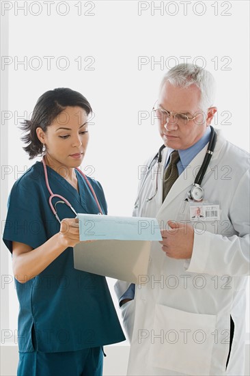 Two doctors reading document. Photo : Rob Lewine