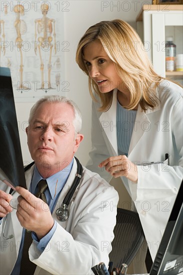 Two doctors looking at x-ray image. Photo : Rob Lewine