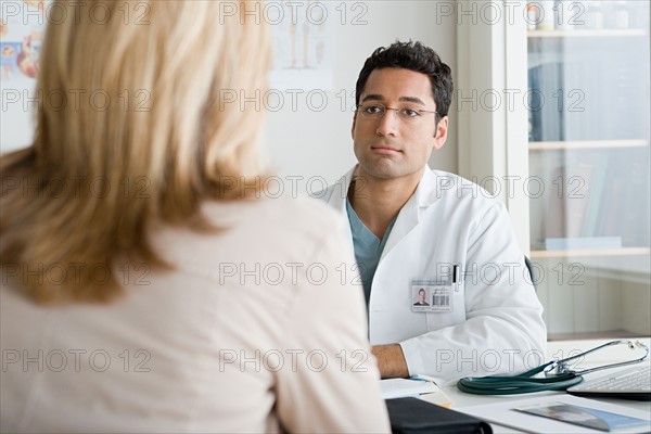 Doctor listening to patient. Photo : Rob Lewine