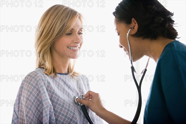 Doctor examining patient. Photo : Rob Lewine