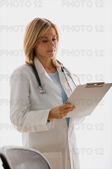 Doctor reading document. Photo : Rob Lewine