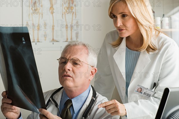 Two doctors looking at x-ray image. Photo : Rob Lewine