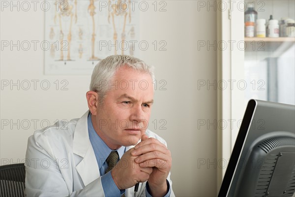 Doctor working on computer. Photo : Rob Lewine