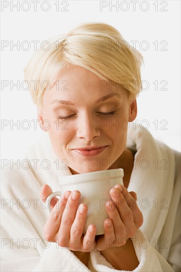 Woman enjoying hot drink. Photo : Rob Lewine