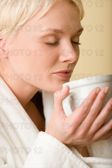 Woman enjoying cup of tea. Photo : Rob Lewine