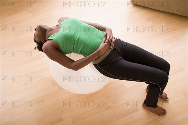 Woman lying on fitness ball. Photo : Rob Lewine