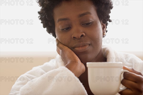 Woman enjoying cup of tea. Photo : Rob Lewine