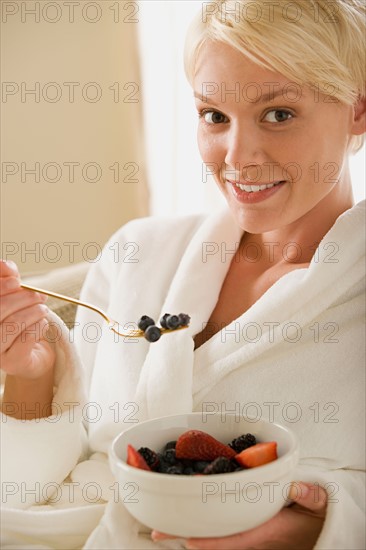 Woman eating fresh fruits. Photo : Rob Lewine