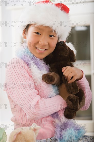 Portrait of girl wearing santa hat. Photo : Rob Lewine