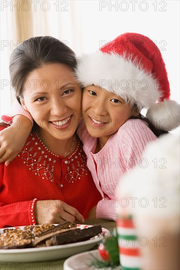Portrait of mother and daughter enjoying christmas meal. Photo : Rob Lewine