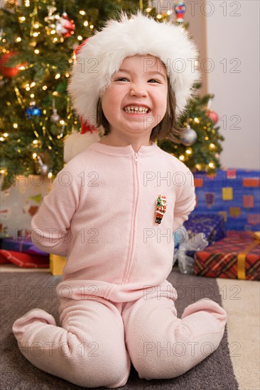 Portrait of girl with presents at Christmas morning. Photo : Rob Lewine