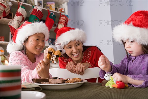 Mother with two daughters playing at Christmas morning. Photo : Rob Lewine