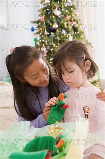 Two sisters (10-11) near Christmas tree. Photo : Rob Lewine