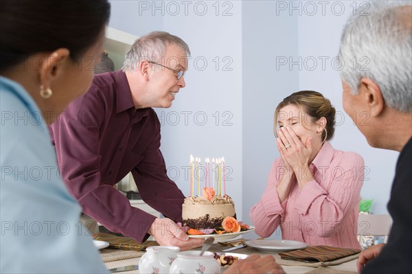 Friends celebrating mature women's birthday. Photo : Rob Lewine