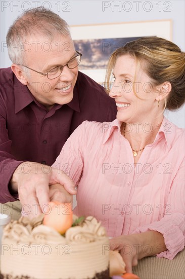 Mature couple celebrating birthday. Photo : Rob Lewine