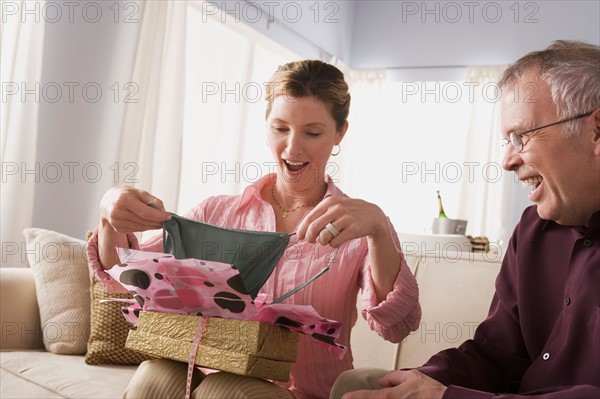 Woman unpacking gift. Photo : Rob Lewine